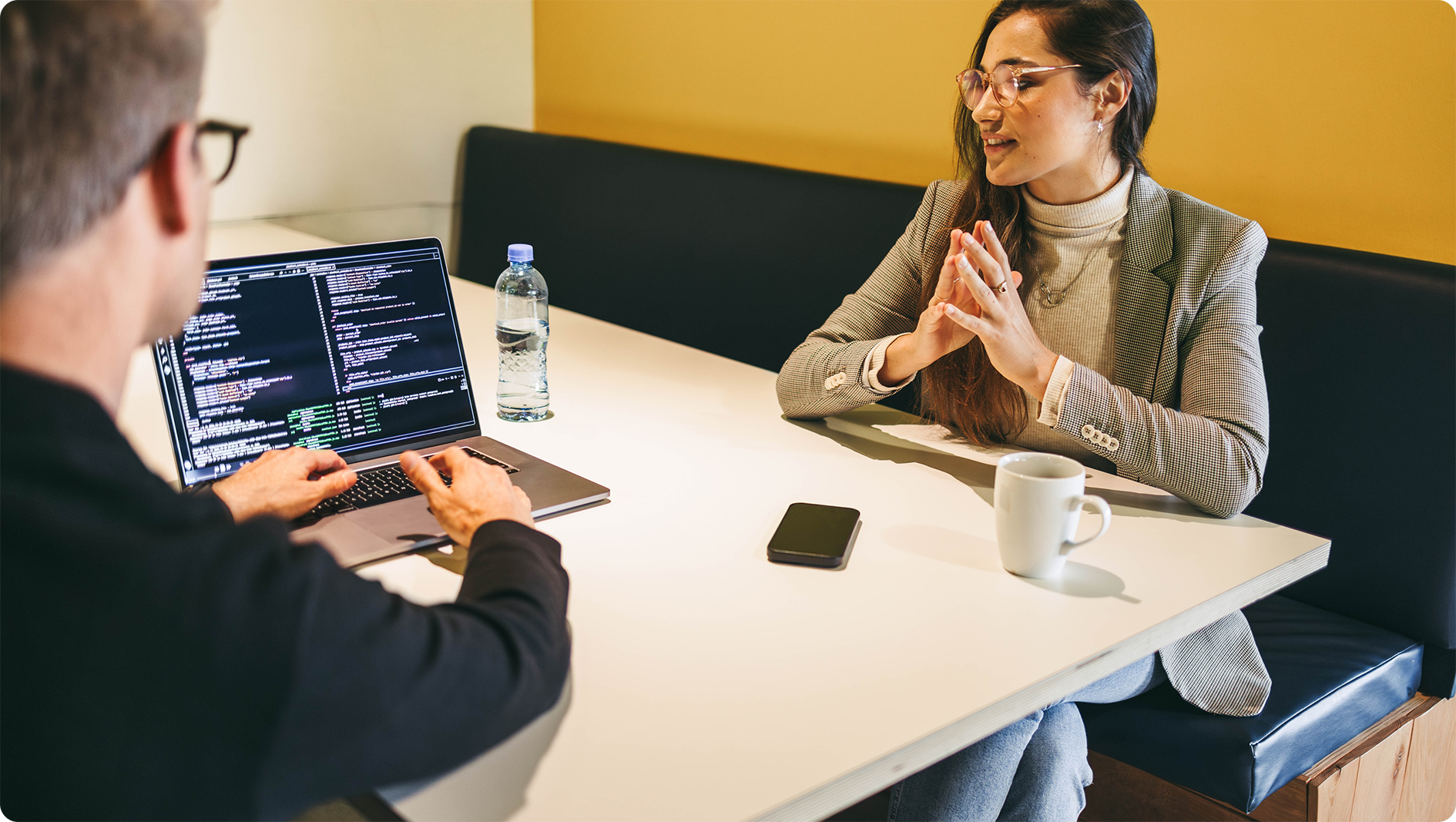 Image of two co-workers collaborating